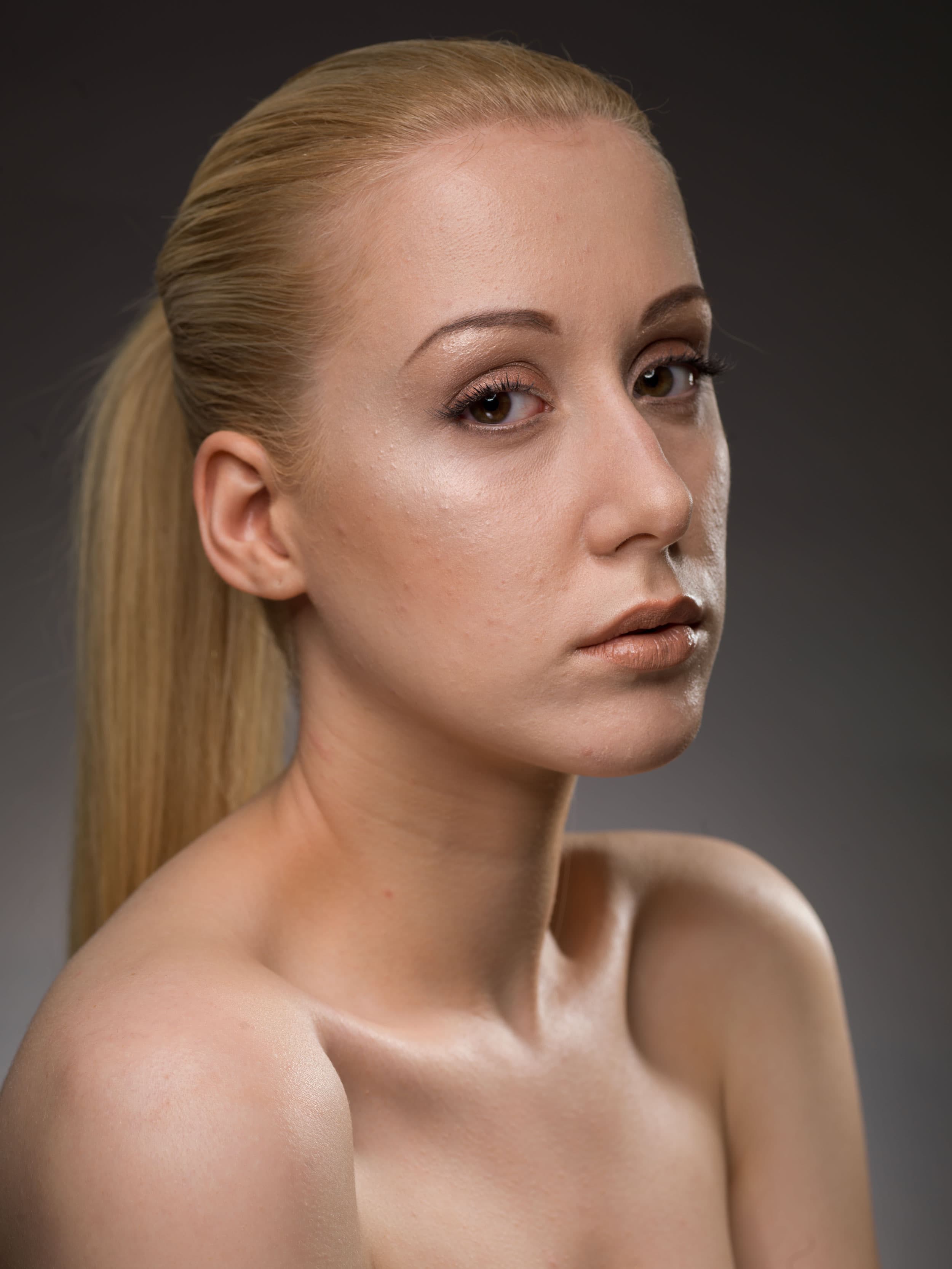 Before — blonde model portrait unretouched, with blemishes, redness, and visible pores